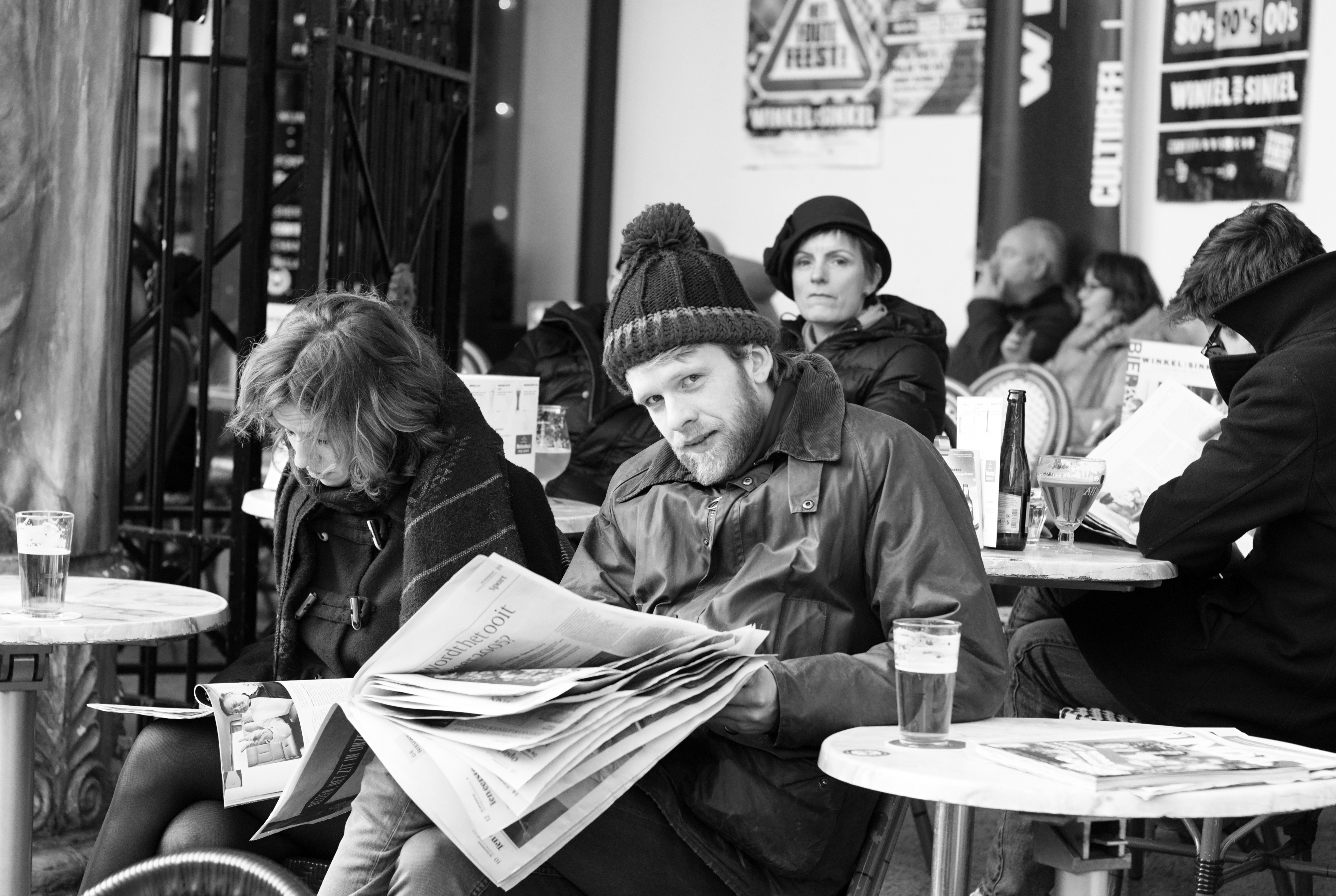 People seated in a café in black and white.