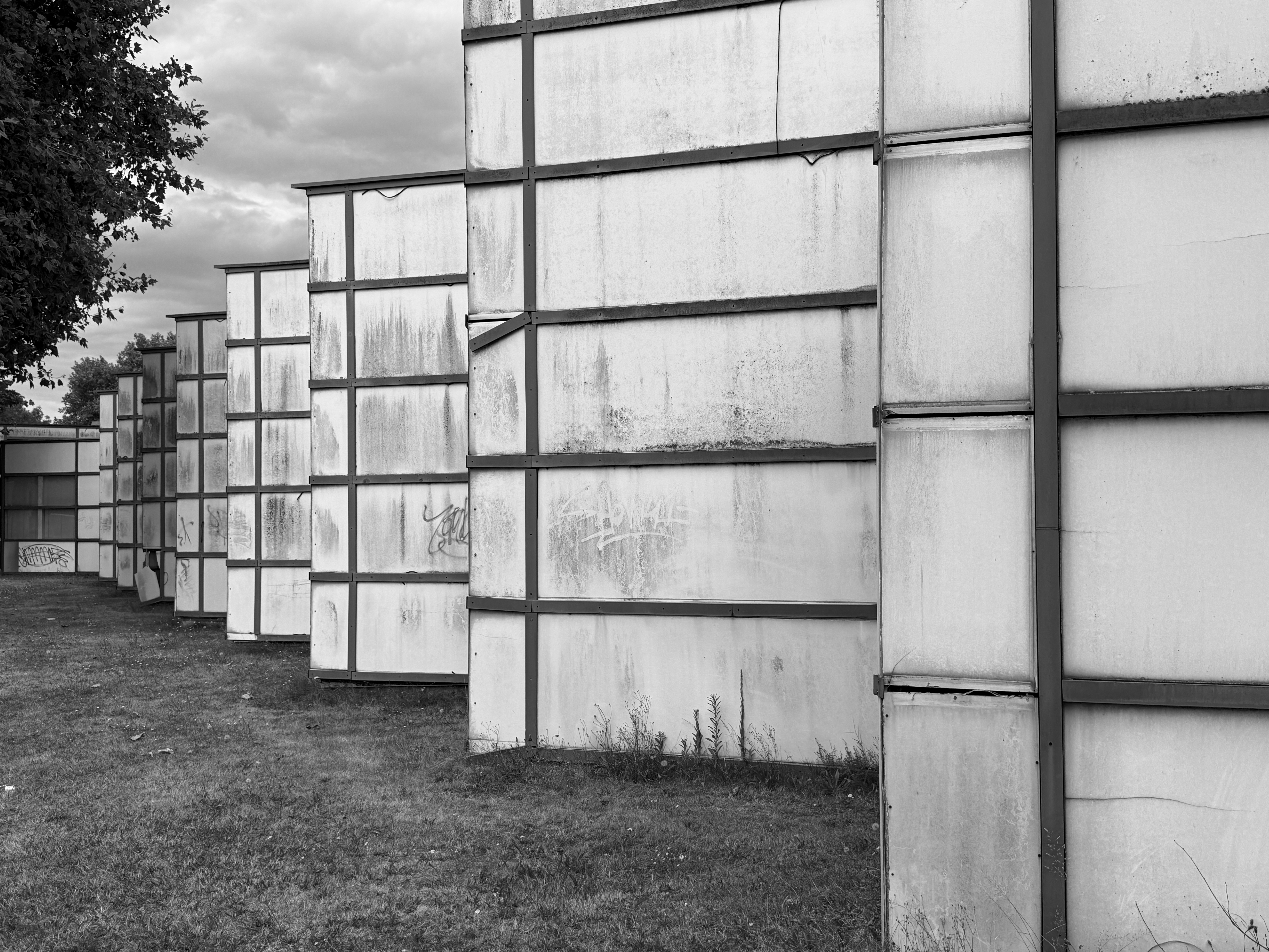 Weathered modular facade with repeating structure in black and white.